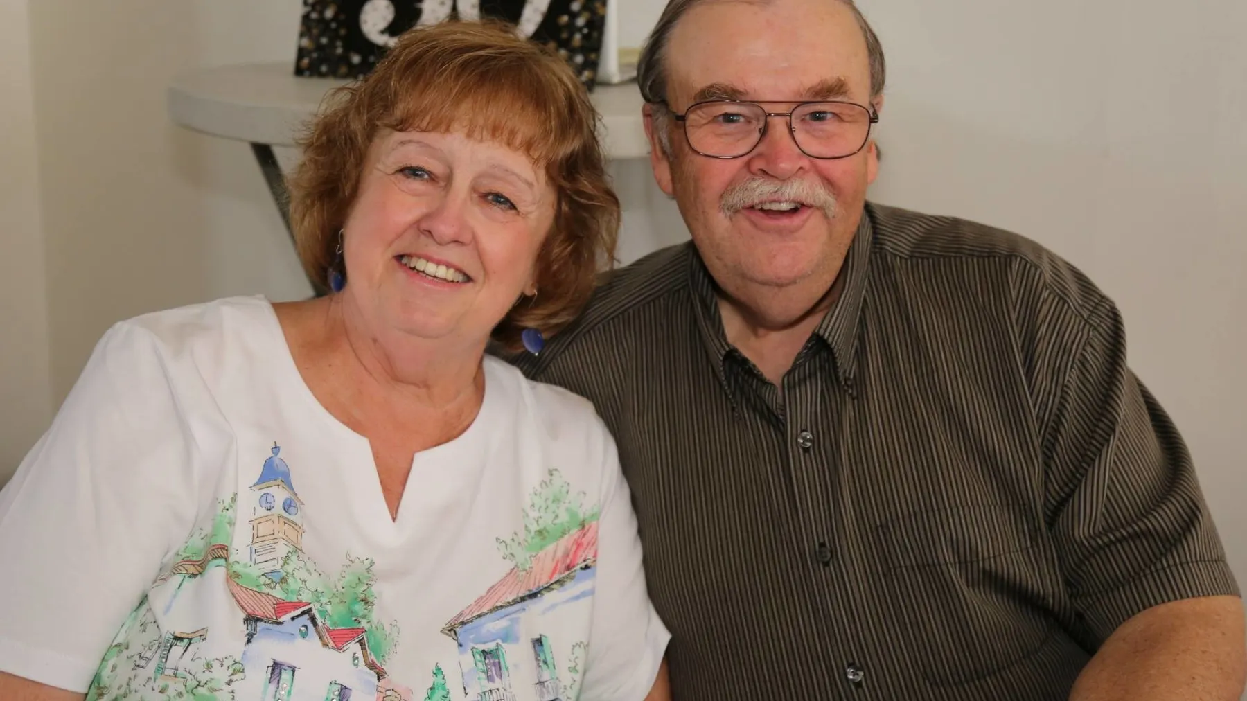 a man and a woman looking at the camera