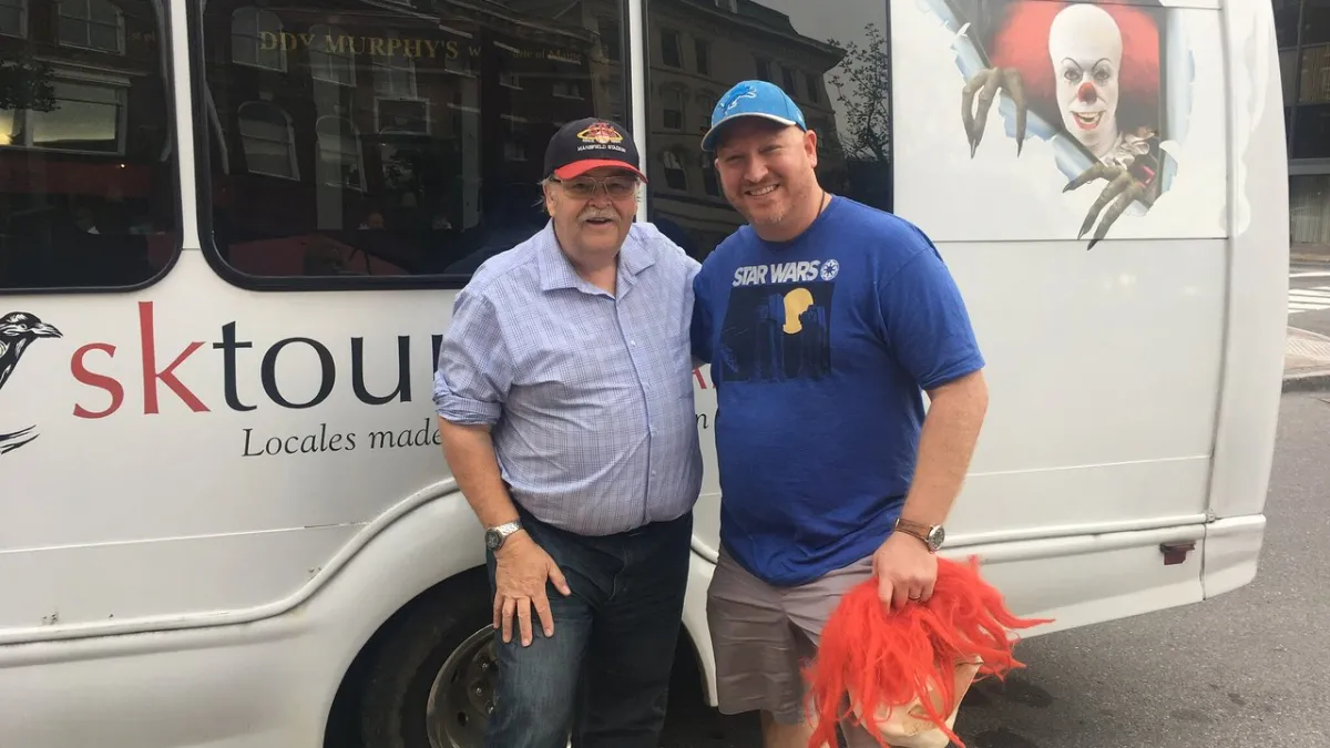 a man standing in front of a bus
