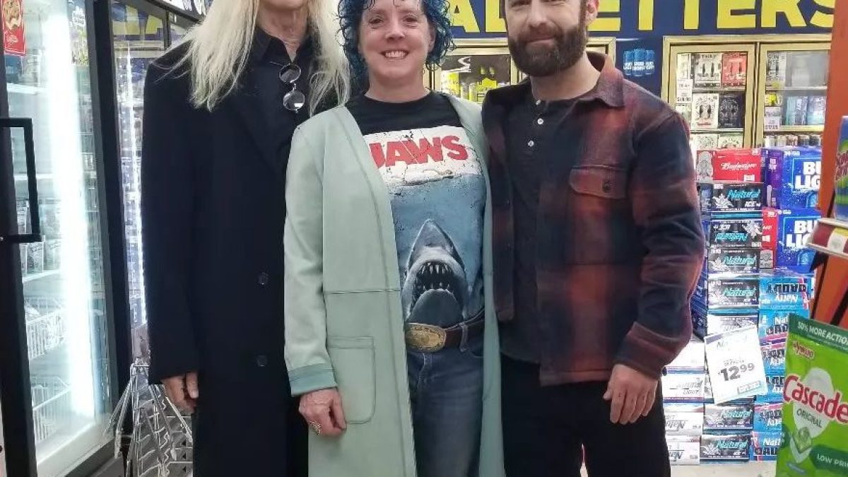 Mick Garris, Miko Hughes standing in front of a store