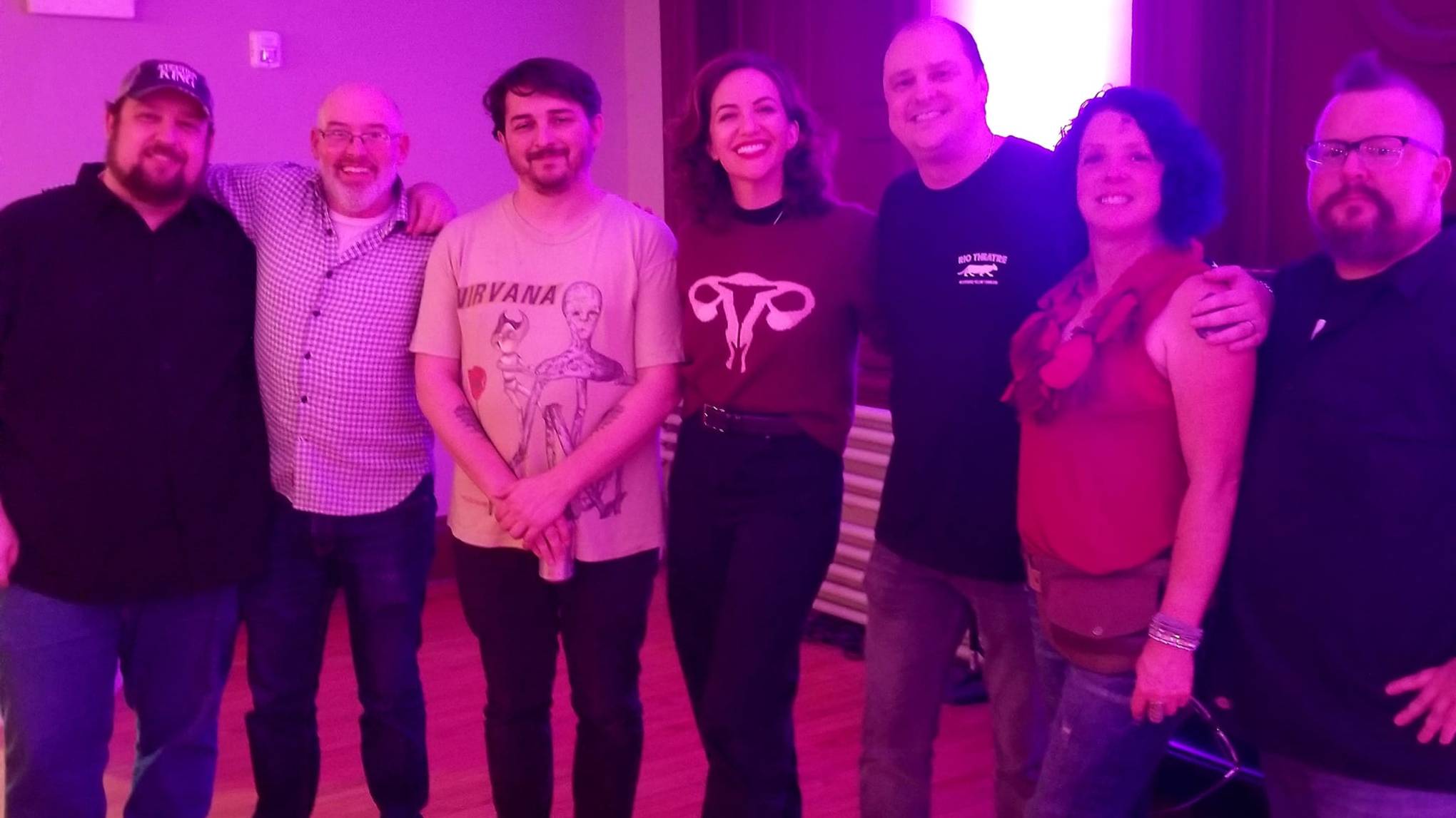Mike Flanagan et al. standing on a stage posing for the camera